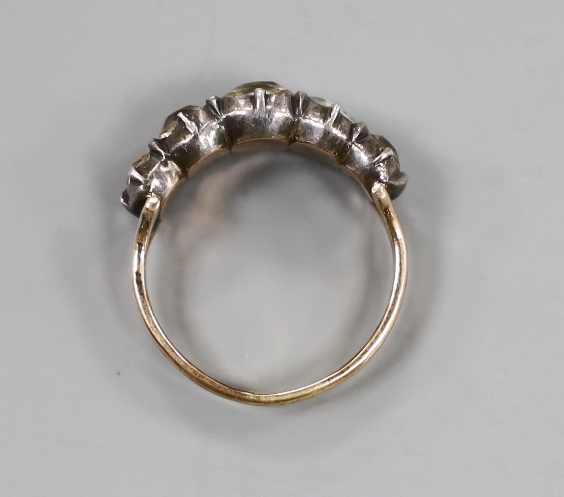 A Georgian yellow metal and graduated five stone paste set half hoop ring, size N, gross weight 3.9 grams.